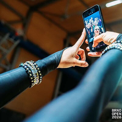 Mladí sportovci na BrnoOpen 2026, pořádaném v Brně, zachyceni při focení na mobilní telefon během sportovní akce.